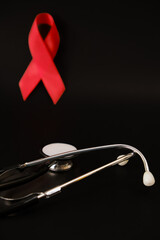 red ribbon symbol of World AIDS Day. Top view. Free copy space.