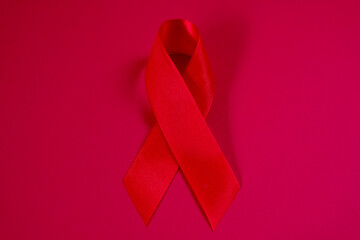 red ribbon symbol of World AIDS Day. Top view. Free copy space.