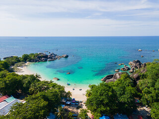 Stunning aerial view of Tanjung Tinggi Beach in Belitung, Indonesia. Known as 'Laskar Pelangi Beach', this popular destination features giant granite boulders and clear turquoise water.