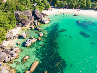 Stunning aerial view of Tanjung Tinggi Beach in Belitung, Indonesia. Known as 'Laskar Pelangi Beach', this popular destination features giant granite boulders and clear turquoise water.
