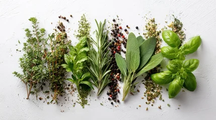 A variety of fresh herbs and spices are neatly arranged on a white surface showcasing thyme basil rosemary and sage among others for cooking enthusiasts. © mila103