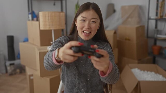 Woman playing video games in new home surrounded by moving boxes, capturing joyful unpacking moment in apartment's cozy interior. - Powered by Adobe