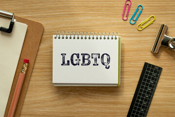 There is notebook with the word LGBTQ. It is an abbreviation for Lesbian, Gay, Bisexual, Transgender, Questioning as eye-catching image.