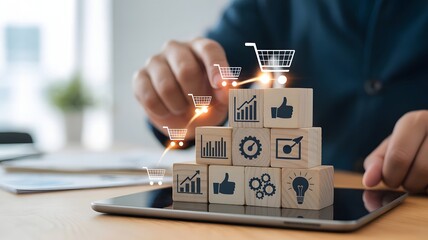 Digital marketing and e-commerce growth concept with wooden blocks showing analytics, shopping cart, engagement, ideas, and strategy icons on a tablet symbolizing online business success and performan