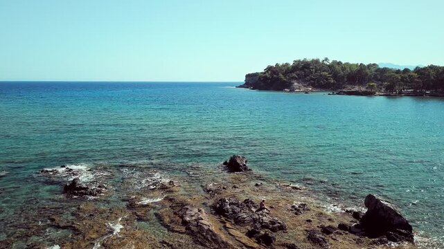 Drone view of Phaselis Bay with turquoise water and rocks. Beautiful Mediterranean landscape near Kemer, Antalya, Turkey.