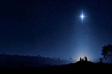 Nativity scene silhouette under the bright star of Bethlehem shining on the holy family. Christmas concept.