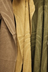 Obraz premium Soft clean towels hanging on a hook. Colorful towels in a laundry room, in bathroom, on a store shelf.