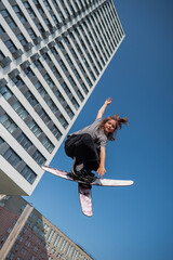 Girl practices skiing tricks on a trampoline. 