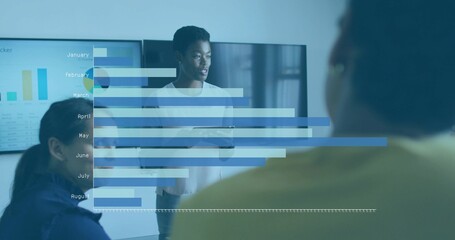 Presenting woman wearing light blouse explaining monthly bar chart in boardroom, holding tablet