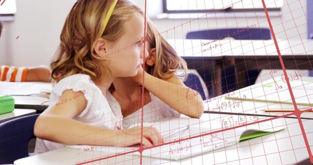 Sitting girl in white top yellow headband leaning toward classmate in class, papers, red math grid