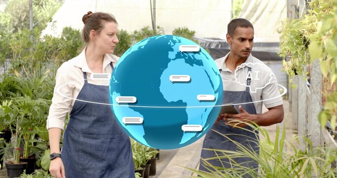 Walking duo in dark aprons holding tablet, checking plants in nursery with digital globe, AI cloud - Powered by Adobe