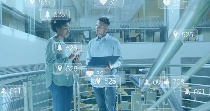 Reviewing man wearing shirt and woman in blouse sharing laptop and phone on mezzanine, AR overlays