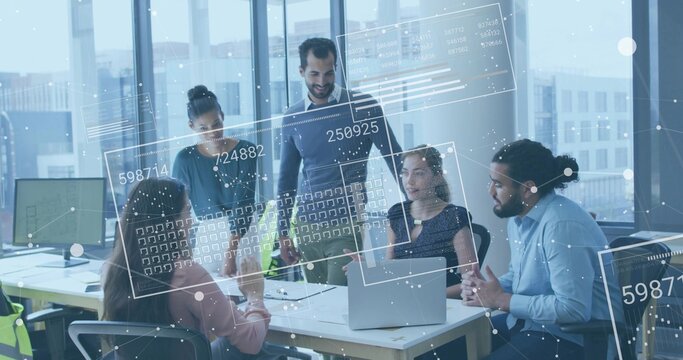 Leading manager wearing sweater leaning forward presenting data HUD at office meeting with laptops