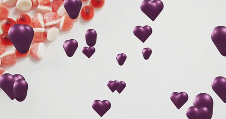 Floating purple 3D hearts drifting over white backdrop with red and white sugared gummies