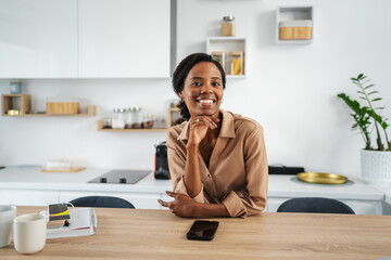 African american woman smiling confidently in modern kitchen
