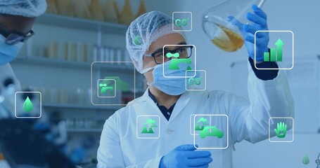 Female scientist inspecting Erlenmeyer flask with amber sample in lab, in PPE and green overlays