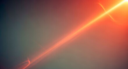 Abstract orange light streak and lens flare on dark background