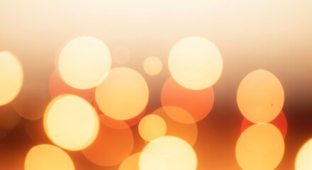 Soft focus bokeh lights in warm orange and yellow hues, creating a dreamy and abstract background with glowing circles