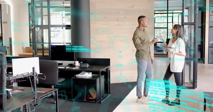 Woman gesturing at tablet, speaking, man high-fiving as AR overlay annotating design in tech review