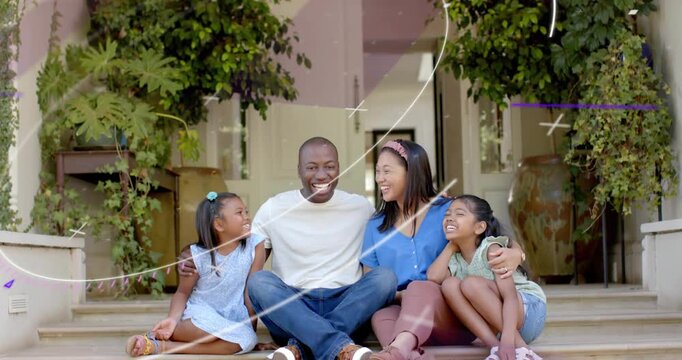 Dad placing arms around kids, streaks passing over family, smiling on stoop for marketing