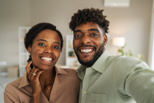 Happy young black couple taking selfie together