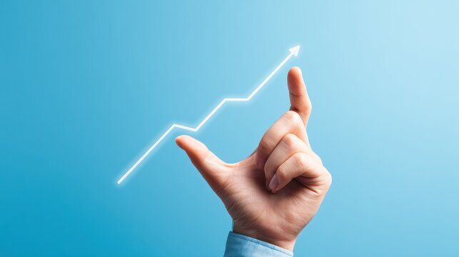 Hand holding glowing upward trending line graph against blue background