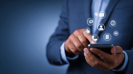 Businessman interacts with glowing communication icons on a smartphone.