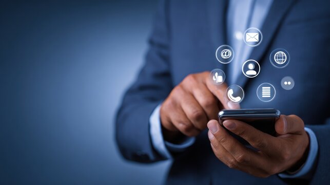 Businessman interacts with glowing communication icons on a smartphone.