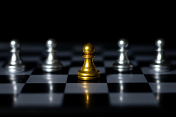 Golden chess knight with fallen silver pieces on chessboard and stock market chart background, symbolizing business strategy and financial investment.