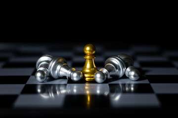 Golden pawn standing among silver pawns on chessboard symbolizing leadership, success, individuality, and business strategy.