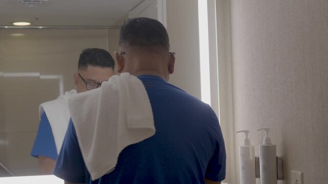 Applying lotion in the hotel bathroom