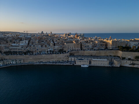 Malta Valletta Grand Harbour entrance with historic Fort St Elmo and breakwater aerial drone view.

