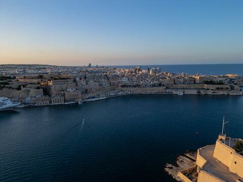 Malta Valletta Grand Harbour entrance with historic Fort St Elmo and breakwater aerial drone view.
