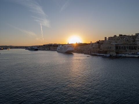 Malta Valletta Grand Harbour entrance with historic Fort St Elmo and breakwater aerial drone view.
