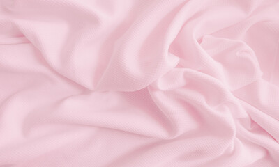 Pink crumpled  fabric background. Wavy cloth texture