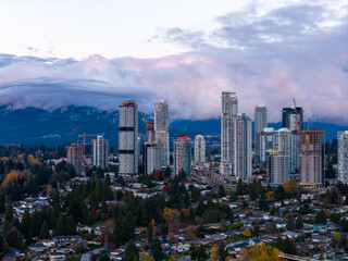 Obraz premium Burnaby City Skyline With Modern Highrise Towers Over Suburban Neighborhoods and Mountains