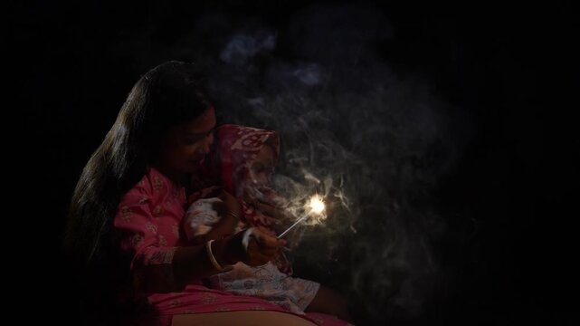 A mother and her child burning crackers on Diwali.