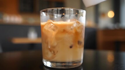 A time-lapse capturing the creation of a delightful iced coffee with a smooth, - Powered by Adobe