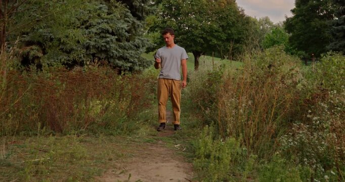 A symbolic cinematic scene showing a young man burying his smartphone to free himself from digital addiction and find peace, mindfulness, and connection with nature under a beautiful cloudy sky.