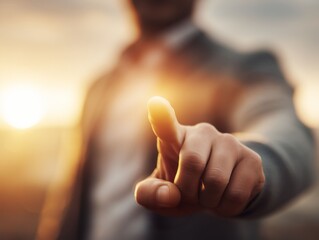 Reaching for the Horizon: A person's outstretched index finger points towards a bright, promising future bathed in the warm, golden light of dawn, symbolizing anticipation and potential.