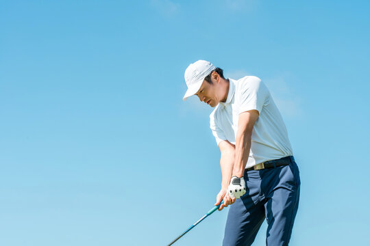 Male golfer playing golf on a golf course (tee shot, golf competition)
