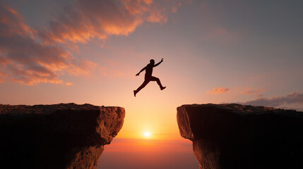 Silhouette of a person leaping across a chasm at sunset with dramatic sky