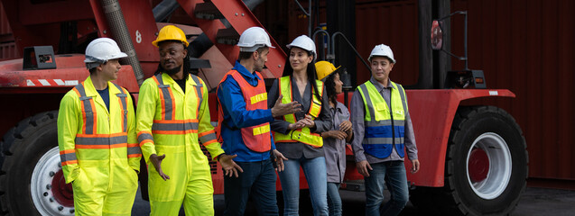 Group of diverse industrial workers standing confidently in front of cargo containers, symbolizing...