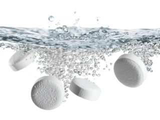 Several white effervescent tablets dissolving and creating bubbles in clear water isolated on transparent background
