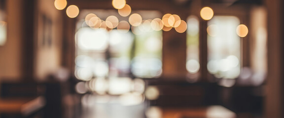 Blurred cafe interior with warm lighting, wooden textures, and soft focus. Modern seating area and decorative elements, suitable for lifestyle and creative backgrounds.