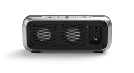 A sleek portable rectangular audio device with dual speaker grilles metallic trim and control buttons on top A blue indicator light is visible along with USB and audio ports