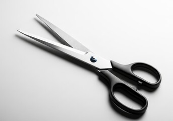 Sharp open scissors featuring metallic blades and textured black handles joined by a blue rivet on a bright white surface with soft shadows
