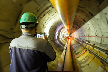 Fototapeta premium Soft focus and blurred lighting background of engineer or technician control to take a photo. Underground tunnel infrastructure. Transport pipeline by Tunnel Boring Machine for electric train subway
