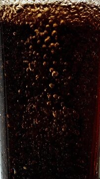 Close Up Of Dark Soda With Bubbles Rising In A Glass