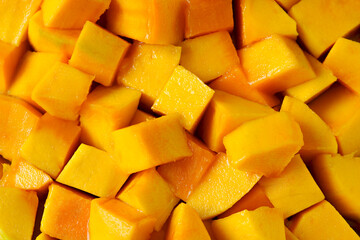 Wallpaper of cut or diced mango cubes in a vivid yellow tone, highlighting the natural sweetness and freshness of the fruit.